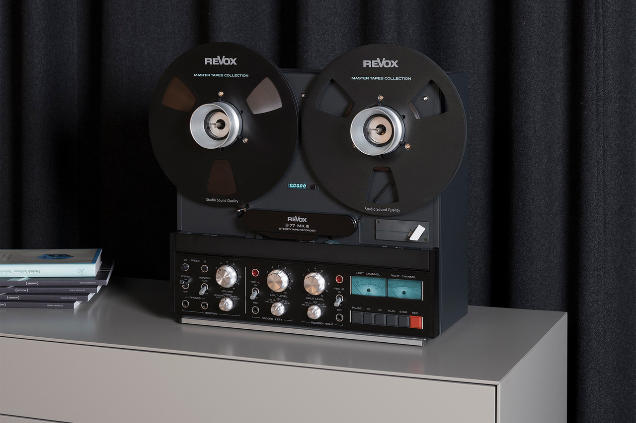 An angled lifestyle shot of the Revox B77 MK III, highlighting the sculptural presence of the spinning reels and the hand-assembled craftsmanship that defines the Black Forest 