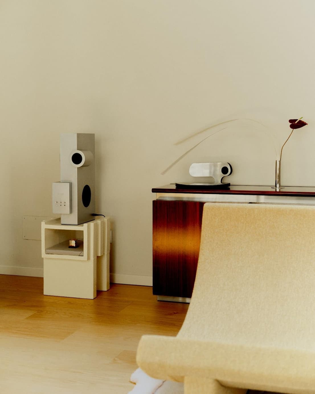 Transparent Brutalist Speaker displayed in a warm minimalist interior beside contemporary furniture and sculptural décor during Milan Design Week installation styling